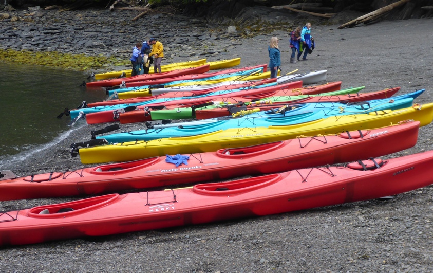 Description: Colorful kayaks on the beach